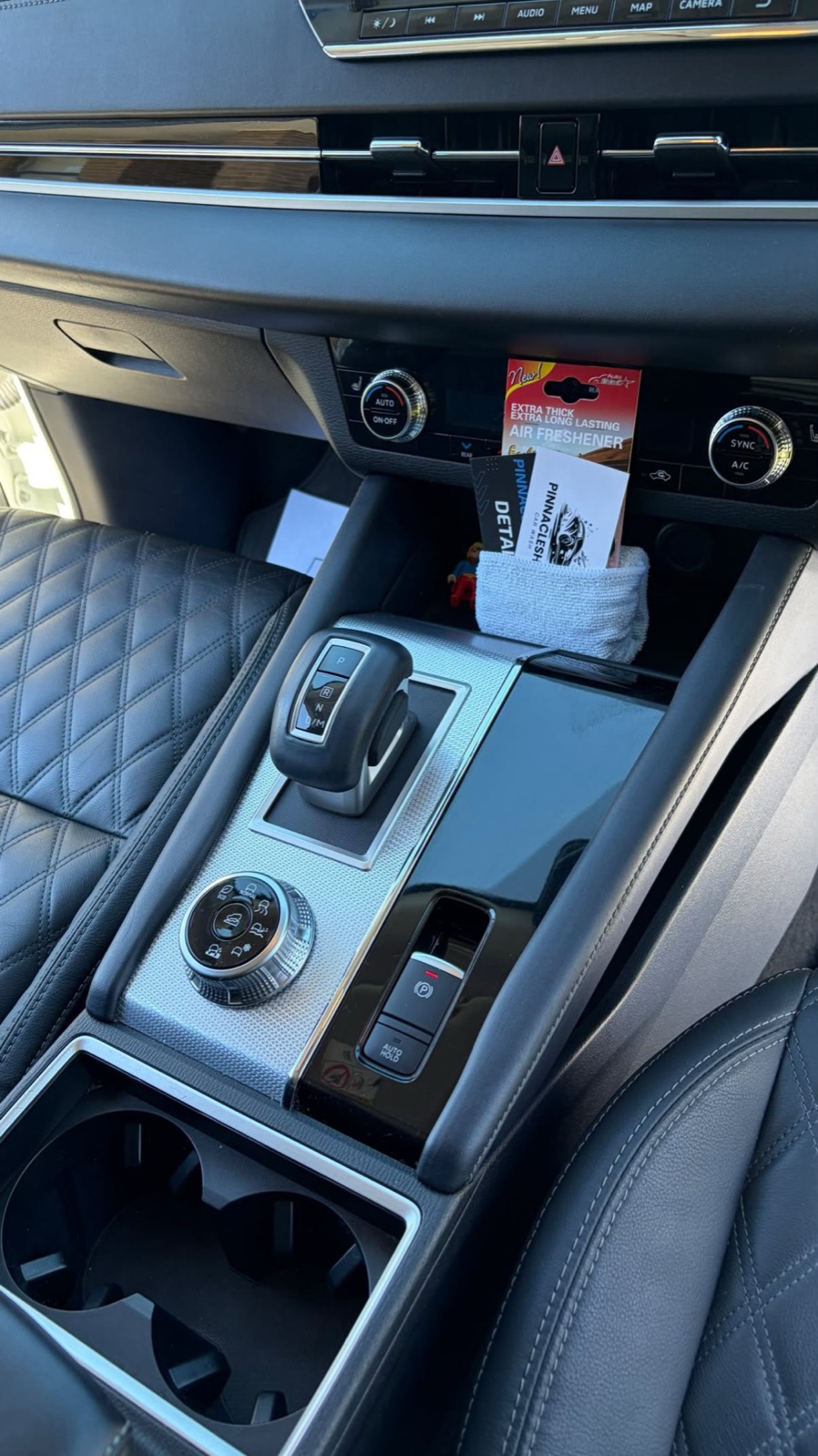 Centre console after an interior detail, gear selector, drive mode dial and cup holders spotless