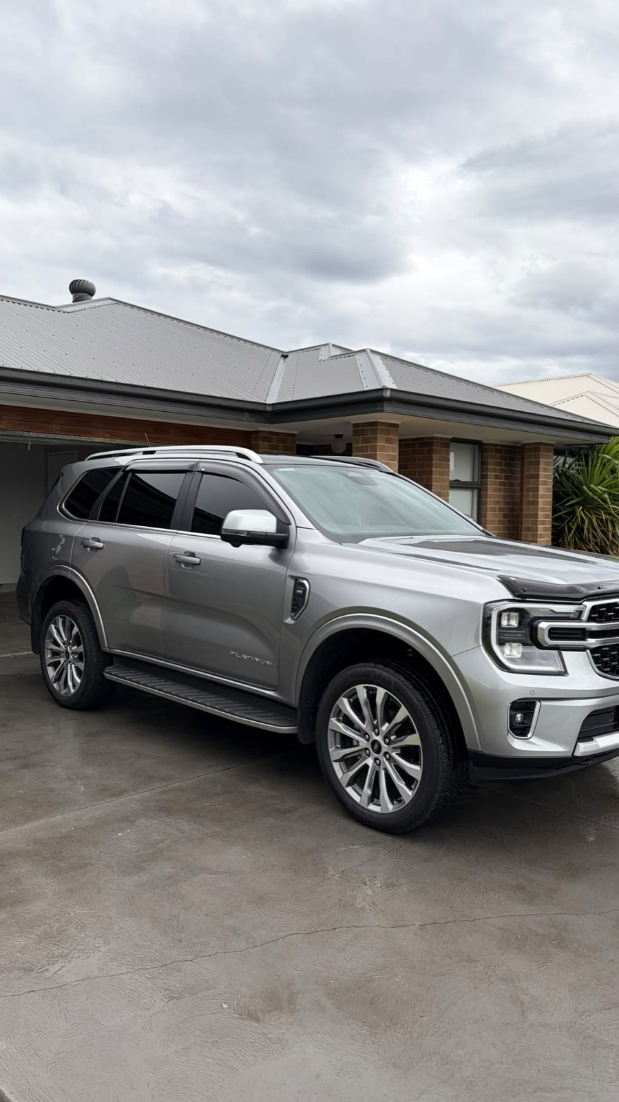 Silver Ford Everest Platinum in the driveway after an exterior detail, paint and wheels gleaming